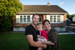 Kayne and Sheree Clifton with Alexis in front of the home they are selling by auction. Photo / Richard Robinson.