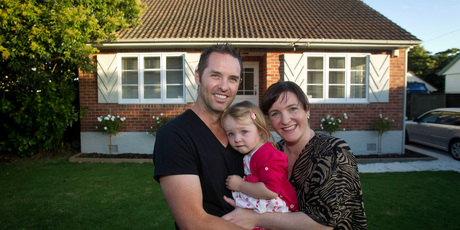 Kayne and Sheree Clifton with Alexis in front of the home they are selling by auction. Photo / Richard Robinson.