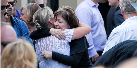 Cyndy McDonald, right, is comforted by a friend at the funeral of her son Cameron in Meadowbank. Photo / Jason Dorday