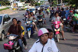 Residents flee on motorcycles to high ground after receiving tsunami warning signals after an earthquake off Indonesia's western coast shook this Thai southern resort province of Phuket. Photo / AP