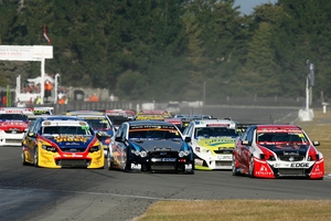 Fabian Coulthard (red car) leads the pack at round two of the V8 SuperTourers at Ruapuna. Photo / Alex Mitchell/Terry Marshall