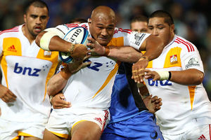 Arizona Taumalolo of the Chiefs looks to break from a tackle by Richard Brown of the Force. Photo / Getty Images