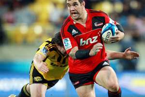 Corey Flynn of the Crusaders is tackled by Richard Buckman of the Hurricanes. Photo / Getty Images