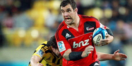 Corey Flynn of the Crusaders is tackled by Richard Buckman of the Hurricanes. Photo / Getty Images