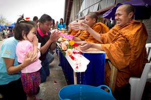 Suwan Unlahmai and her daughter Sienna Speck are blessed by a monk. Photo / Natalie Slade