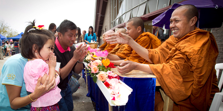 Suwan Unlahmai and her daughter Sienna Speck are blessed by a monk. Photo / Natalie Slade
