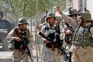 Members of Afghan security force rush to the site of a battle in Kabul, Afghanistan yesterday. Photo / AP