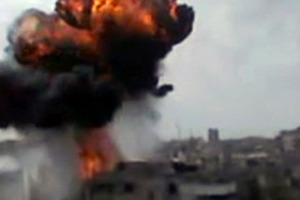 In this image made from amateur video released by the Shaam News Network, smoke billows an impact following purported shelling in Homs, Syria. Photo / AP