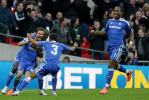 Juan Mata (left) is mobbed by teammates after scoring in Chelsea's FA Cup semifinal win over Spurs yesterday. Photo / AP