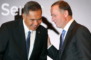 New Zealand's Prime Minister John Key, right, talks with Indonesian Minister of Trade Gita Wiryawan. Photo / AP
