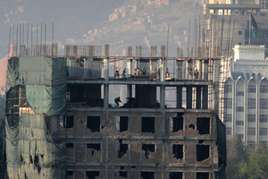 Afghan special forces are seen on top of a building which was occupied by militants in Kabul. Photo / AP