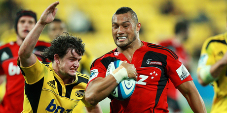 Robbie Fruean of the Crusaders breaks away frome the tackle of Richard Buckman of the Hurricanes on his way to scoring a try. Photo / Getty Images.