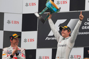 Mercedes Formula One driver Nico Rosberg of Germany, right, celebrates after winning the Chinese Grand Prix in Shanghai. Photo / AP