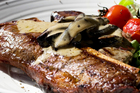 T-Bone steak with mushroom sauce. Photo / Richard Robinson T-Bone steak with mushroom sauce. Photo / Richard Robinson