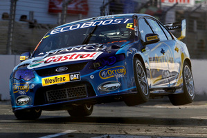 Mark Winterbottom gets some air during his winning race on the Hamilton street circuit yesterday. Photo / Christine Cornege
