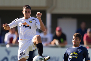 Wellington defender Luke Rowe has a spring in his step as he contests the ball with Auckland City's Luis Corrales. Photo / Brett Phibbs