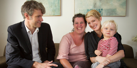 Nick Dravitzki sits with surrogate Adriana Gracen while Keely O'Shannessy holds Leo at their home in Ponsonby. Photo / Greg Bowker