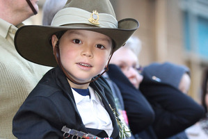 Veterans and children alike watched the Anzac Day parade. Photo / AP