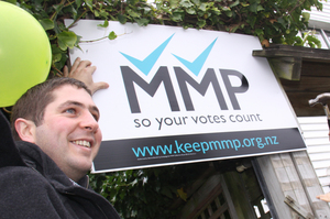 Oliver Christeller (left), holds up an MMP supporters sign outside his flat on Nairn St, Wellington, with Wellington mayor Celia Wade-Brown. Photo / APN