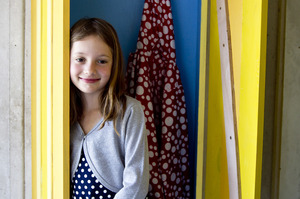Greta Newcombe checking out the family's new coat cupboard by the back door. Photo / Dean Purcell