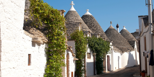 Distinctive trulli houses line a street in Alberobello, Puglia. Photo / Thinkstock
