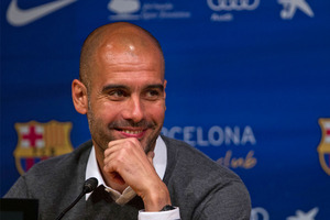 Barcelona's coach Pep Guardiola smiles during a press conference where he announced his resignation in Barcelona, Spain. Photo / AP