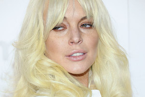Lindsay Lohan's attitude on the set of Glee has been slammed, but a rep says she was working hard. Photo / AP