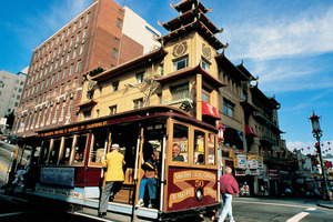 A cable car passes the landmark 1908 Sing Chong Building in Chinatown, San Francisco. Photo / SFCVB