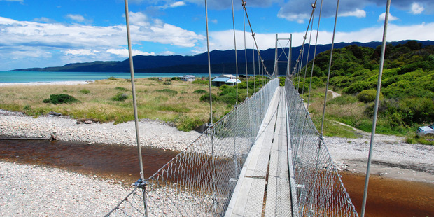 Swing bridges are negotiated in darkness during Stump the Hump, but can be appreciated in daylight during other hikes. Photo / Tuatapere Hump Ridge Track