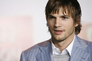 Ashton Kutcher has teamed up with snack food company Popchips for a series of fake dating service adverts. Photo / AP