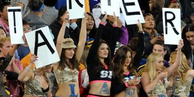 The women held up letters spelling "Meet us Starters Bar" during the Highlanders v Blues match last month. Photo / Otago Daily Times
