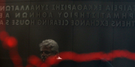 A man is reflected in the chart with stock prices at the Greek Stock Exchange in Athens. Greek parties in favour of austerity measures got just 33pc of the vote. Photo / AP