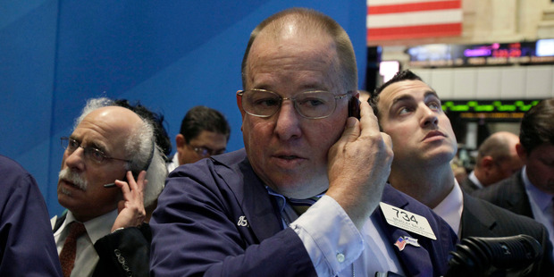 Trader Bradley Bailey, center, works on the floor of the New York Stock Exchange. Photo / AP
