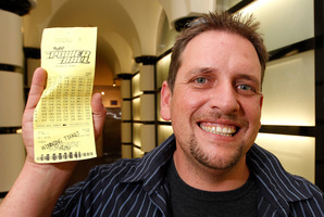 Trevor with his winning $26,000,000 Lotto ticket. Photo / Mark Mitchell