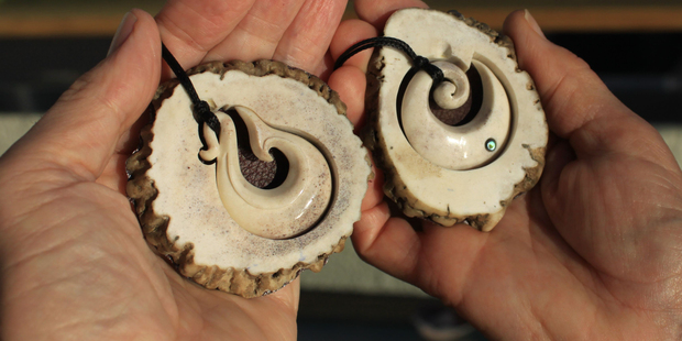 Fishhook and koru bone carvings produced by Jim and Chris Eagles at Pacific Carvers. Photo / Jim Eagles