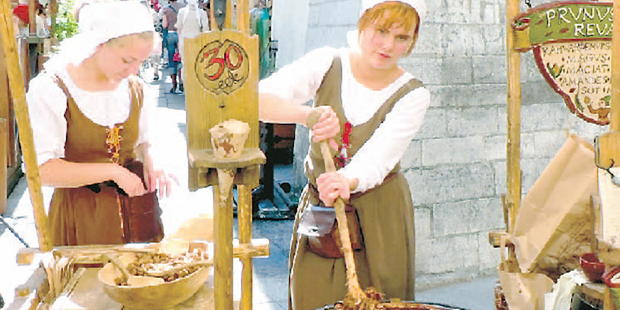 Women stir cauldrons of cinnamon and nuts for sale at Tallinn's gothic town hall. Photo / Jim Eagles