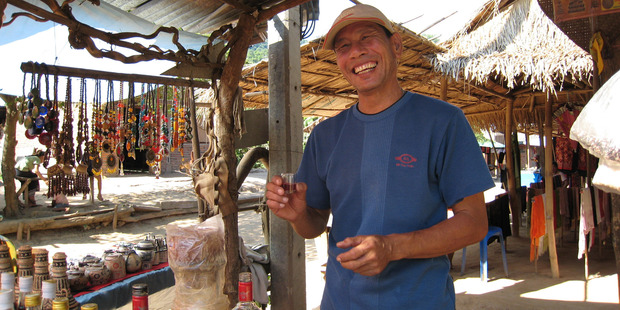 A man sells lao bong ya at Ban Xang Hai village. Photo / AAP