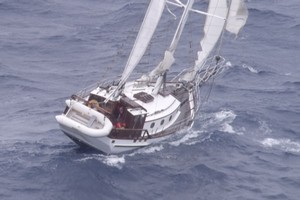 The ketch Cheval de Mer was 'rocking and rolling' in stormy seas as new communications gear was winched down to it. Photo / Northland Emergency Services Trust