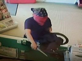 The woman threatens a shopkeeper with the 10-inch dagger. Photo / Supplied