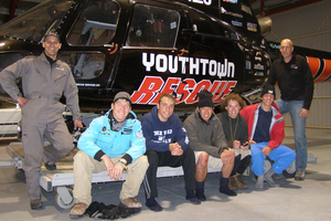 Crewman Mark Bond and five happy young American hikers who were rescued on Saturday night after getting into trouble on Mt Ngauruhoe. Photo / Youthtown Rescue helicopter