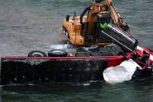 The truck lies in the Taihape River after driving off the road. Photo / Warren Buckland