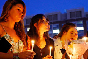 Boston University students including Tori Pinheiro, left, and Austin Brashears' girlfriend, hold a candlelight vigil on Marsh Plaza at Boston University.
Photo / AP