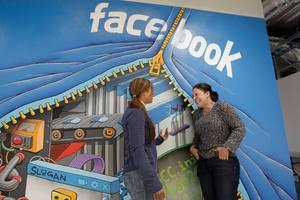 Two workers chat each other at Facebook headquarters in Menlo Park, California. Photo / AP