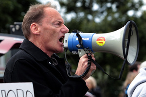 Protester John Minto was arrested within a minute of arriving at a peaceful rally. Photo / Brett Phibbs