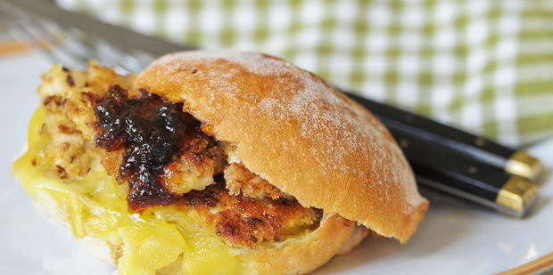 Chicken schnitzel served on a bun with plum jelly and cheese are a great treat to enjoy while watching telly. Photo / Jason Dorday
