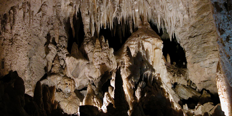 Stalactites hang into the cave like like tapering organ pipes. Photo / Ruakuri Cave, Waitomo