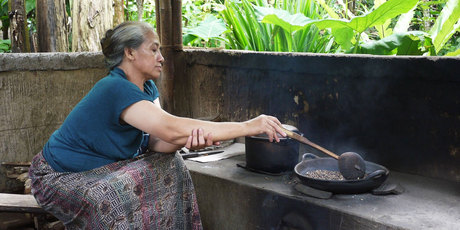 A woman roasts beans to make kopi luwak, after they've been conveniently processed by the Asian palm civet. Photo / Kieran Nash
