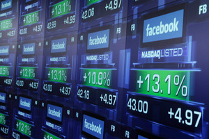 Electronic screens show the price of Facebook shares after they began trading. Photo / AP