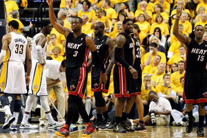 Miami Heat's Dwyane Wade (3), Joel Anthony, LeBron James, and Mario Chalmers (15) celebrate after Wade scored while drawing a foul against the Indiana Pacers. Photo / Getty Images.