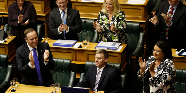 Finance Minister Bill English is congratulated by Prime Minister John Key and his Government colleagues after reading his 2012 Budget in the House. Photo / Mark Mitchell